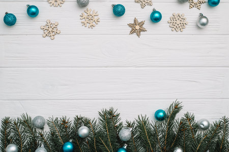 Christmas fir tree with decoration and glitters on wooden background. Christmas background on the...