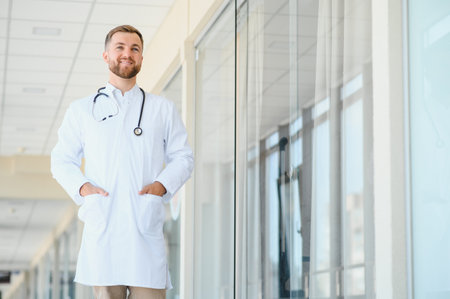 Portrait of a male doctor standing in a hospital corridorの写真素材