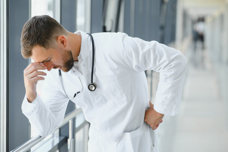 Sad doctor standing in hospital corridor.の写真素材