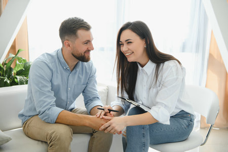 Session with a psychologist, psychotherapist. Young depressed male patient and professional female doctor with notepad. lifestyle. mental health careの写真素材