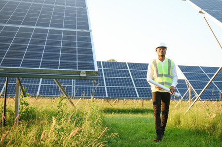 African american technician check the maintenance of the solar panels. Black man engineer at solar stationの写真素材