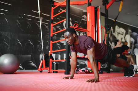 African American athlete working out in the gym.