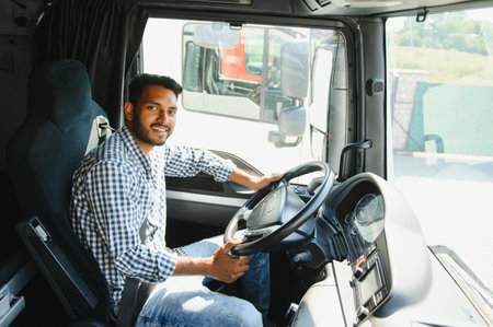 Happy professional truck driver driving his truck. copy space