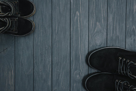 stylish black boots for men on a wooden background, advertising concept. Collection of winter and...