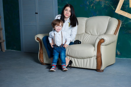 Beautiful woman and her cute little son are hugging and smiling. mom with a beautiful sonの写真素材