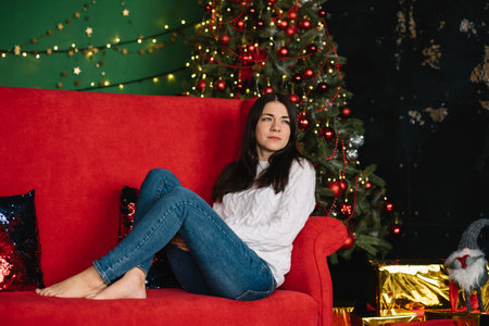 Young beautyful mother with the cute son near Christmas tree with gifts. merry christmasの写真素材