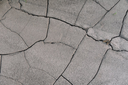 Gray cracked earth ground from drought disaster cause from weather change. The global warming and greenhouse effect cause of agricultural production is reduced.の写真素材
