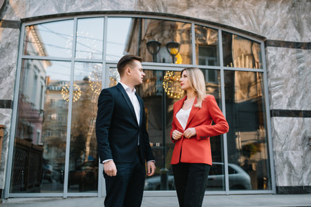 Business people walking and talking in the street ear of modern buildingの写真素材