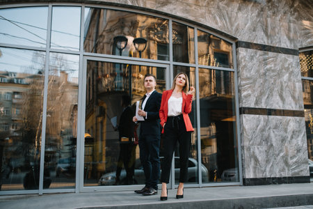 Business people walking and talking in the street ear of modern buildingの写真素材