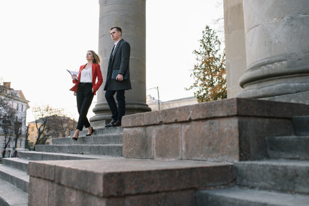 Young business people walking along the street.の写真素材