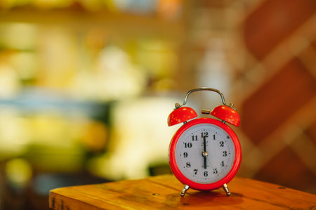 an alarm clock at 6:00 am on a blurry background.の写真素材