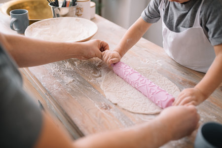 Young man and his son with oven sheet in kitchen. Father with little son on the kitchenの写真素材