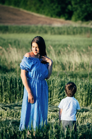 Stilish mother and handsome son having fun on the nature. happy family concept. Beauty nature scene with family outdoor lifestyle. Happy family resting together. Happiness in family life. mother's day.の写真素材
