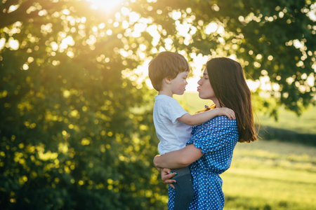 Stilish mother and handsome son having fun on the nature. happy family concept. Beauty nature scene with family outdoor lifestyle. Happy family resting together. Happiness in family life. mother's day.の写真素材