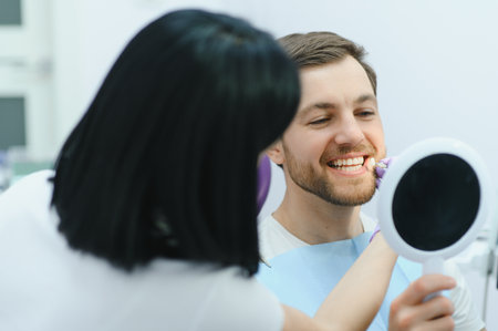Dental care concept. Handsome young guy at the dentist's officeの写真素材
