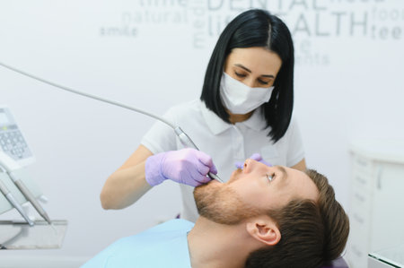 Dental care concept. Handsome young guy at the dentist's officeの写真素材