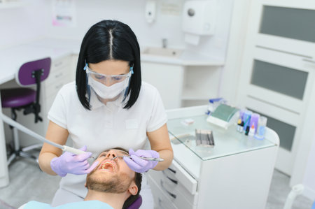 Dental care concept. Handsome young guy at the dentist's officeの写真素材