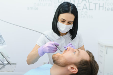Young man at the dentist. Dental care, taking care of teeth. Picture with copy space for background