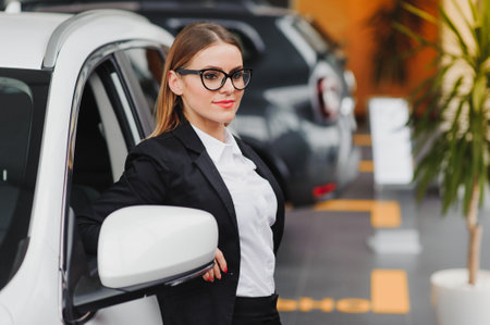business woman in auto salon. concept of female driverの写真素材