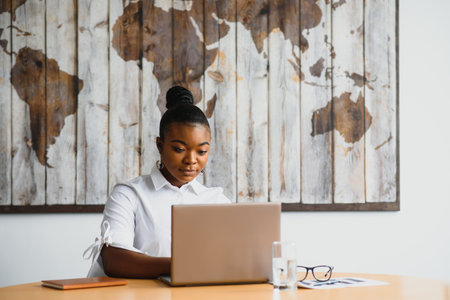 beautiful young african american businesswoman working on computer