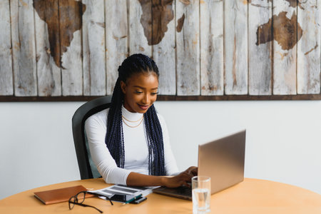 beautiful young african american businesswoman working on computerの写真素材