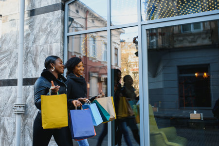 young black women going shopping. African American girls with shopping bags go shoppingの写真素材