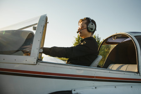 Young woman and pilot in the cockpit of a plane. front view