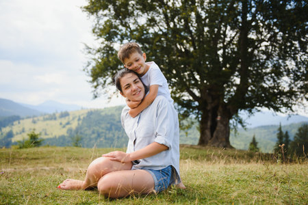 mother and son having rest on vacation in mountainsの写真素材