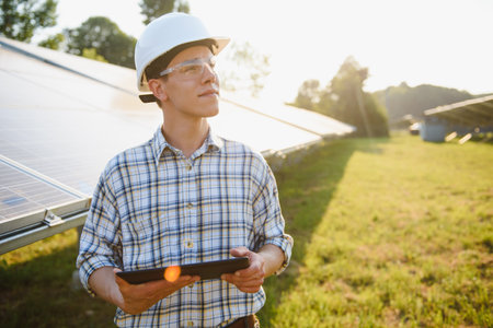 Engineers checking solar panels. Renewable energy.の写真素材