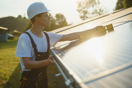Worker installing solar panels outdoors
