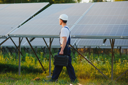 Young adult doing professional training on solar panels plantの写真素材