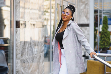 Sexy attractive young black woman in fashionable beautiful clothes with stylish handbag. Trendy...
