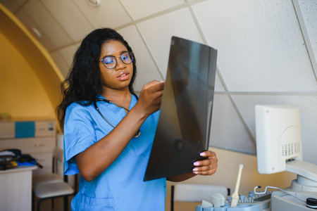 beautiful african american healthcare worker with x-ray, medical international concept, black doctor thinking, modern studentの写真素材
