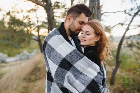 love, relationship, family, season and people concept - smiling couple hugging over autumn natural backgroundの写真素材