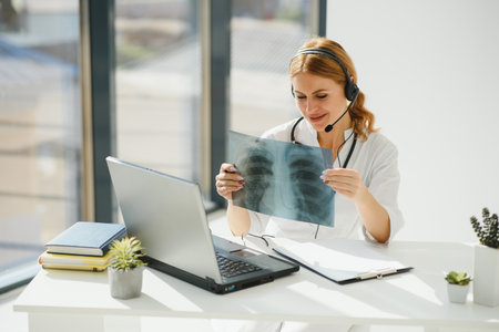 doctor talking with sick person through laptop online system and using mobile digital tablet...