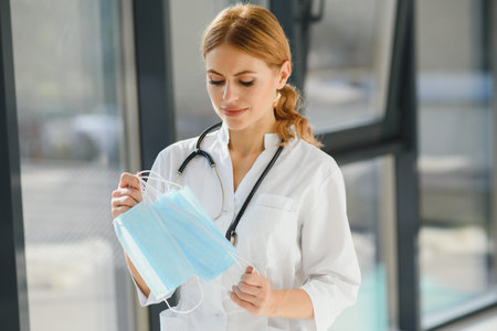 female doctor holding protective masksの写真素材