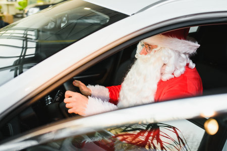 Authentic Santa Claus driving his modern car, outdoorsの写真素材