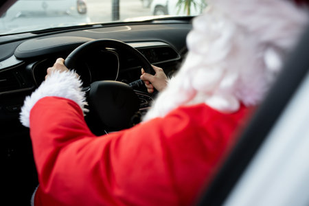 Authentic Santa Claus driving his modern car, outdoorsの写真素材