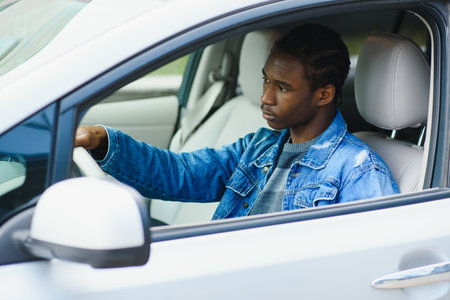 african man inside his new carの写真素材