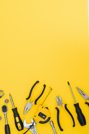 Set of various construction tools. Tools for home repair. Work at a construction site. On a yellow background. Flatly. Flatlayの写真素材