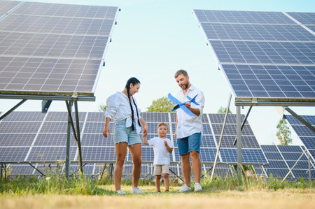 Happy family near solar panels. alternative energy sources.の写真素材