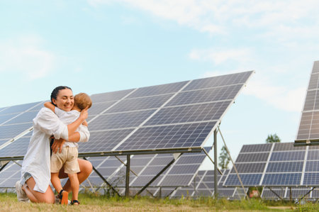 Mother with her little son by solar panels.の写真素材