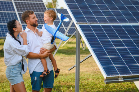 Happy family near solar panels. alternative energy sources.の写真素材