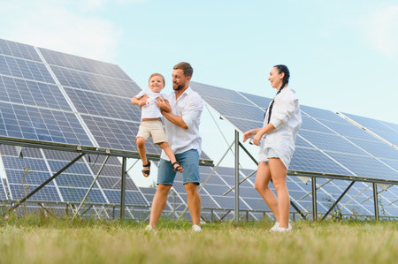 Happy family near solar panels. alternative energy sources.の写真素材