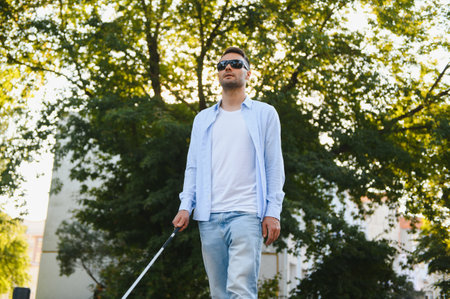 Blind man. Visually impaired man with walking stickの写真素材