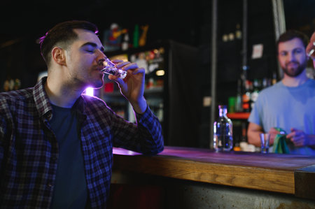 a man drinks vodka at a bar.の写真素材