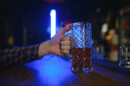 Tasting a good beer. Portrait of thoughtful men drinking beer at the bar.
