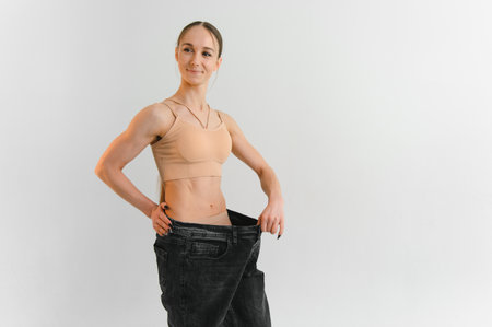 Happy girl showing her slim figure after workout.の写真素材
