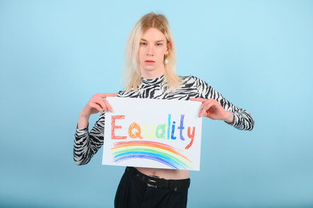 Handsome man wearing make up and woman clothes looking at the camera. positive personの写真素材