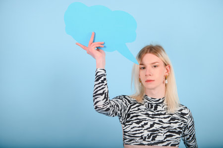 Fashionable young transgender woman on color background.の写真素材